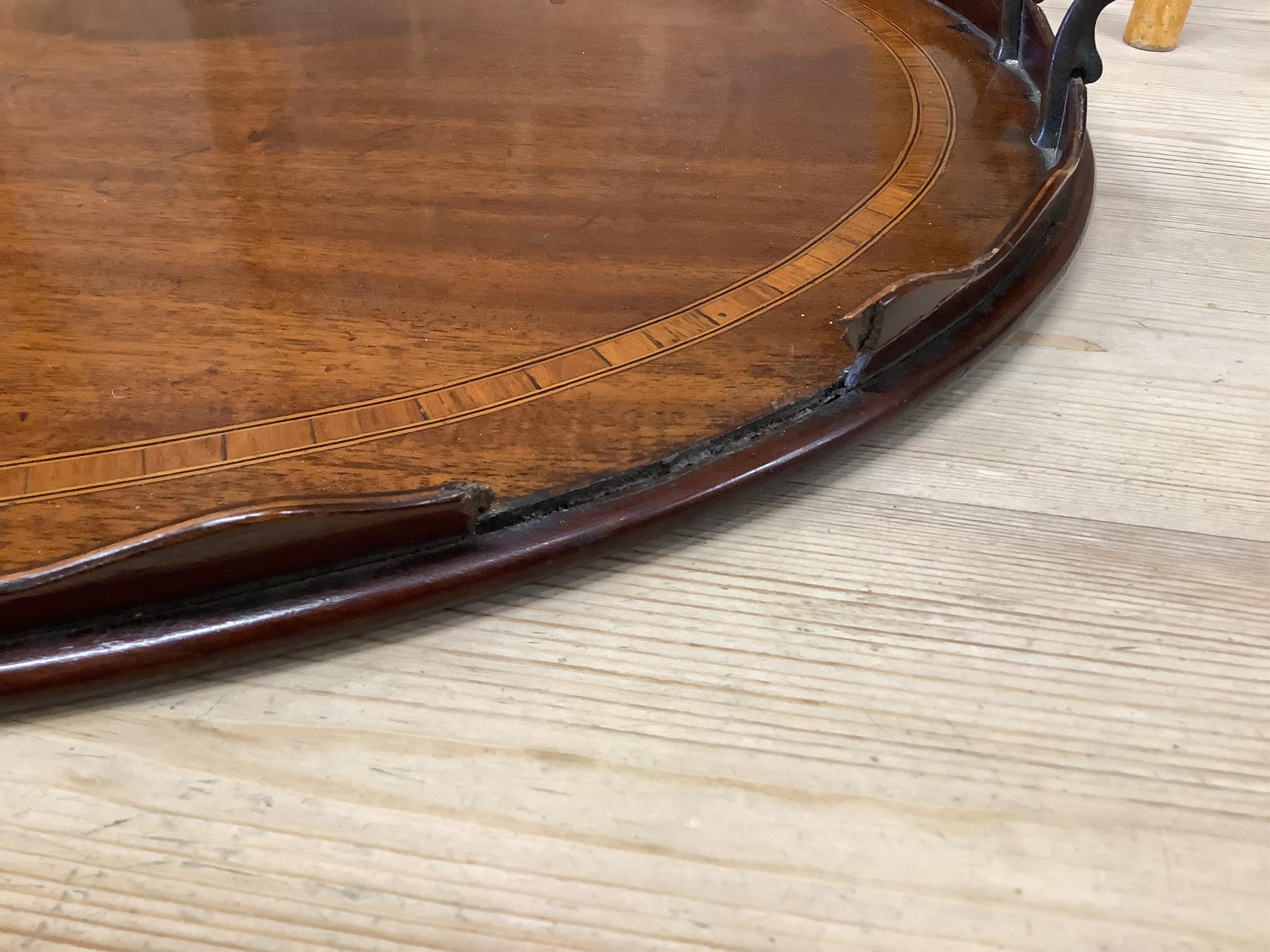 An Edwardian satinwood banded mahogany oval twin handled tea tray, length 73cm, depth 51cm. Condition - poor
